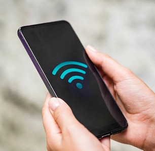 close-up-phone-hands-with-wifi-symbol 1 close up phone hands with wifi symbol 1